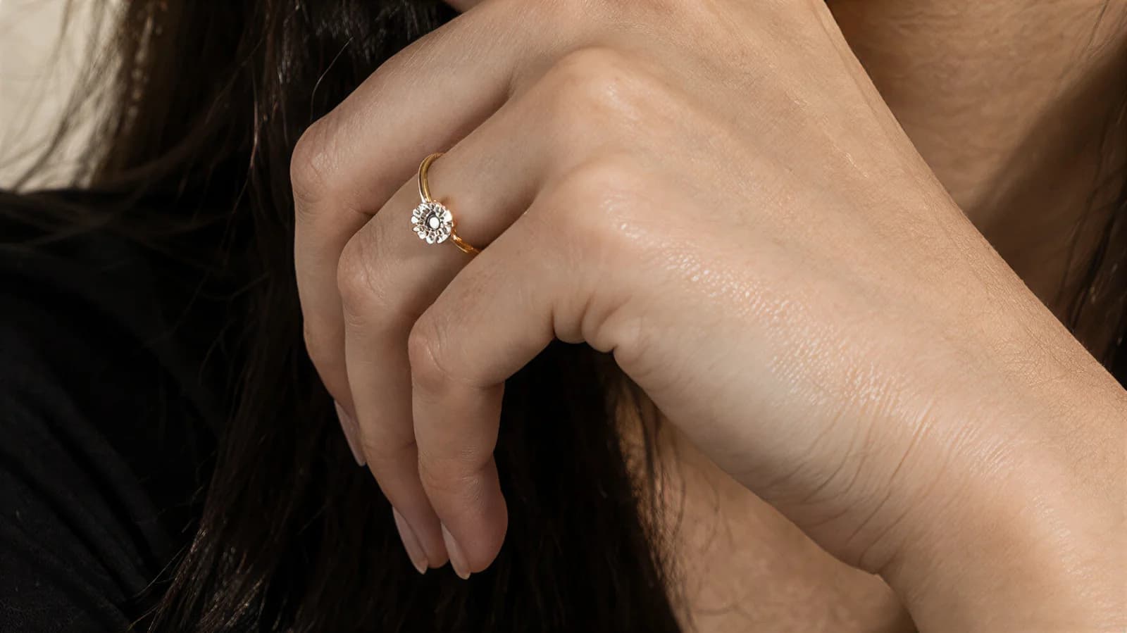Close-up of the solitaire ring on the finger, hand raised