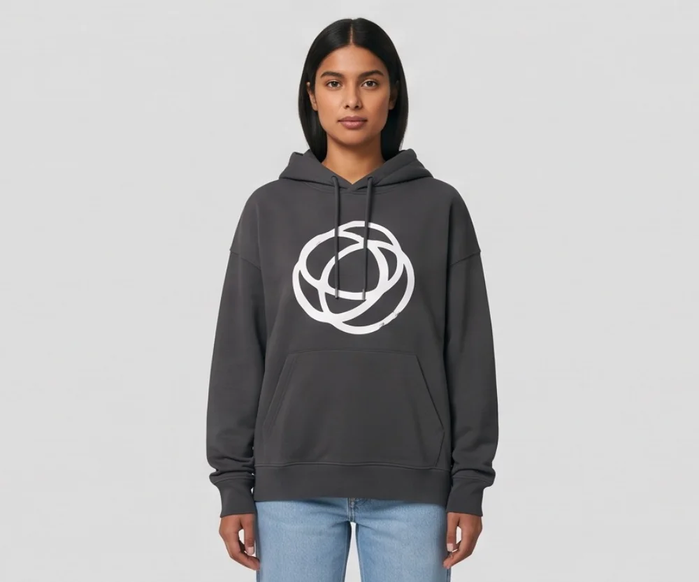A model with a dark bob in a charcoal hoodie with a white circular print and light jeans, front view on a gray backdrop