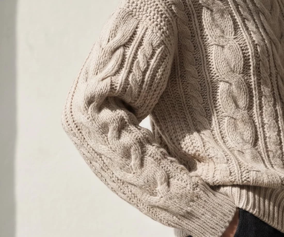 Close-up of the cable pattern on the sweater sleeve as worn, made with Tryly