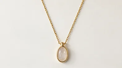Gold pendant necklace with an oval stone