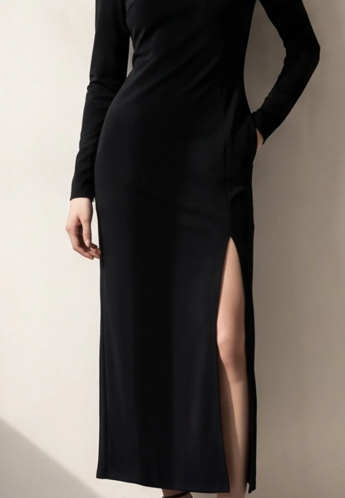 Black column dress, print and logo close-up